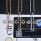 Three cross-shaped pendants on a card with GRA branding