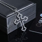 Silver cross necklace on a black box with a card in the background
