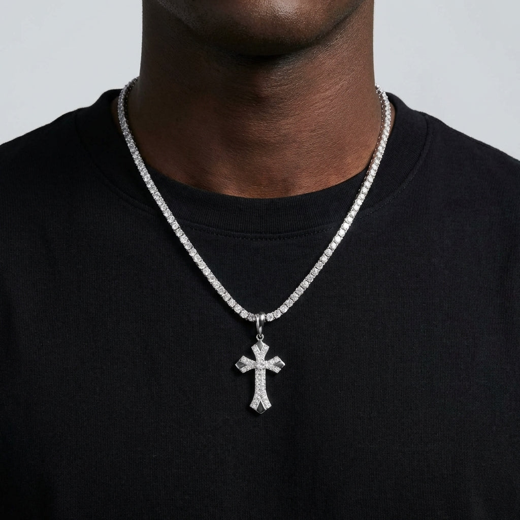 Person wearing a black shirt with a diamond-studded cross necklace.