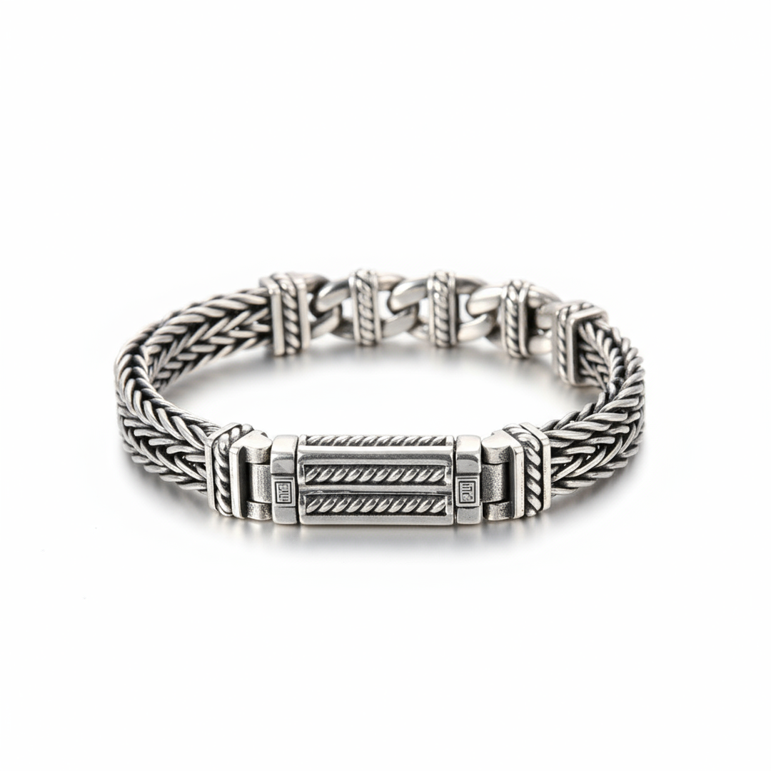 Silver bracelet with braided design on a white background