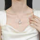 Pearl necklace with silver pendant on a model wearing a white top