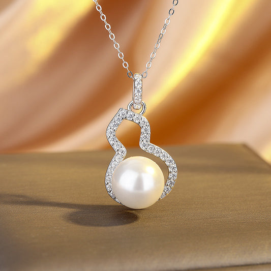 Pearl necklace with a heart-shaped pendant on a beige background