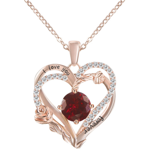 Heart-shaped rose gold pendant with red gemstone and 'I love you' engraving on a white background