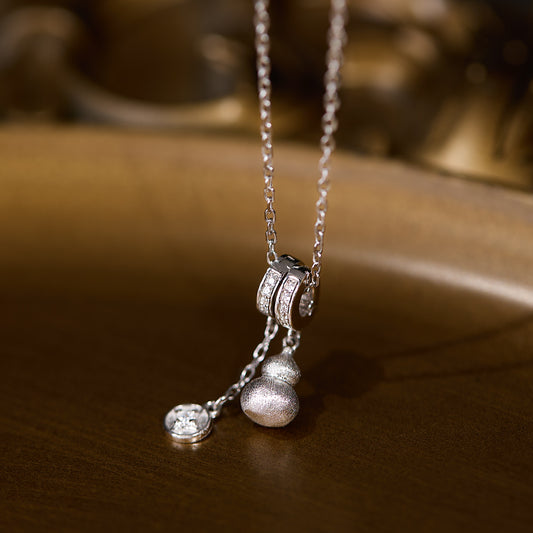 Silver necklace with pendant on a wooden surface