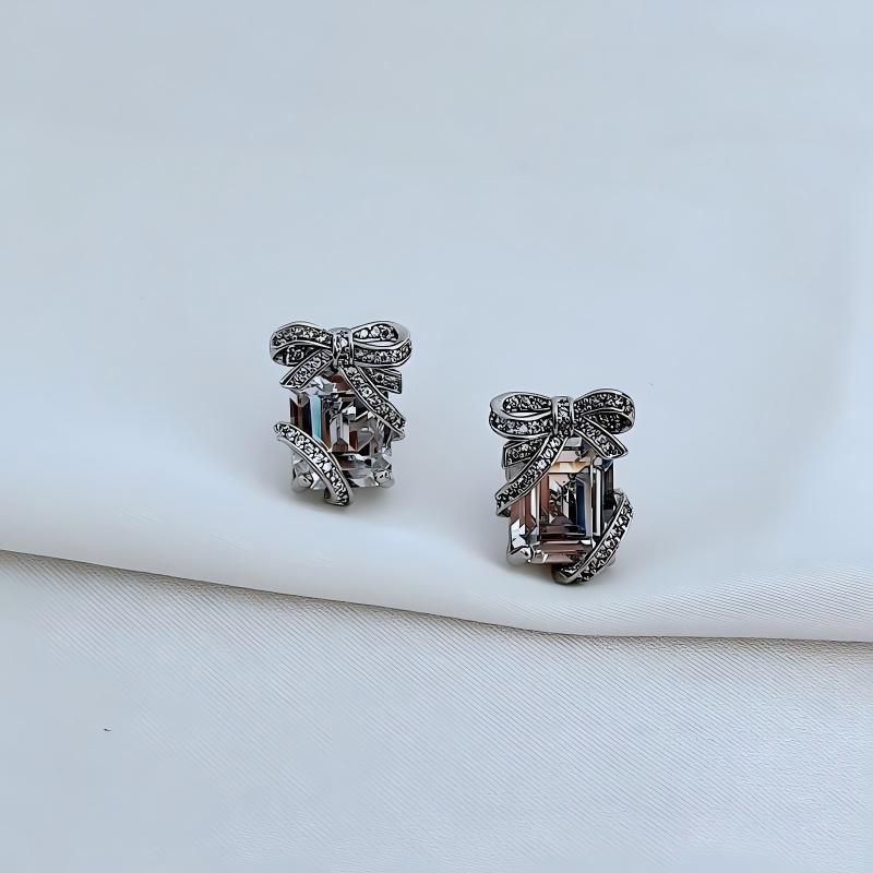 Clean shot of studs on a neutral or festive background (e.g., white marble or dark green velvet), highlighting the gift box shape and green pavé sparkle. Alt: “KATE SPADE Pavé Emerald Present Stud Earrings – Green Gift Box Design.”