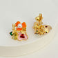 Earrings on a soft white or pale pink background, showcasing the vibrant multicolor floral cluster. Alt: “Kate Spade Abloom in Color Floral Cluster Stud Earrings – Multicolor Enamel Flower Jewelry.”