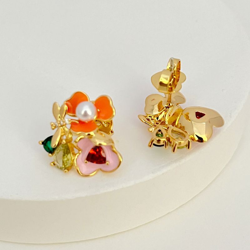 Earrings on a soft white or pale pink background, showcasing the vibrant multicolor floral cluster. Alt: “Kate Spade Abloom in Color Floral Cluster Stud Earrings – Multicolor Enamel Flower Jewelry.”