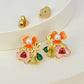 Earrings on a soft white or pale pink background, showcasing the vibrant multicolor floral cluster. Alt: “Kate Spade Abloom in Color Floral Cluster Stud Earrings – Multicolor Enamel Flower Jewelry.”