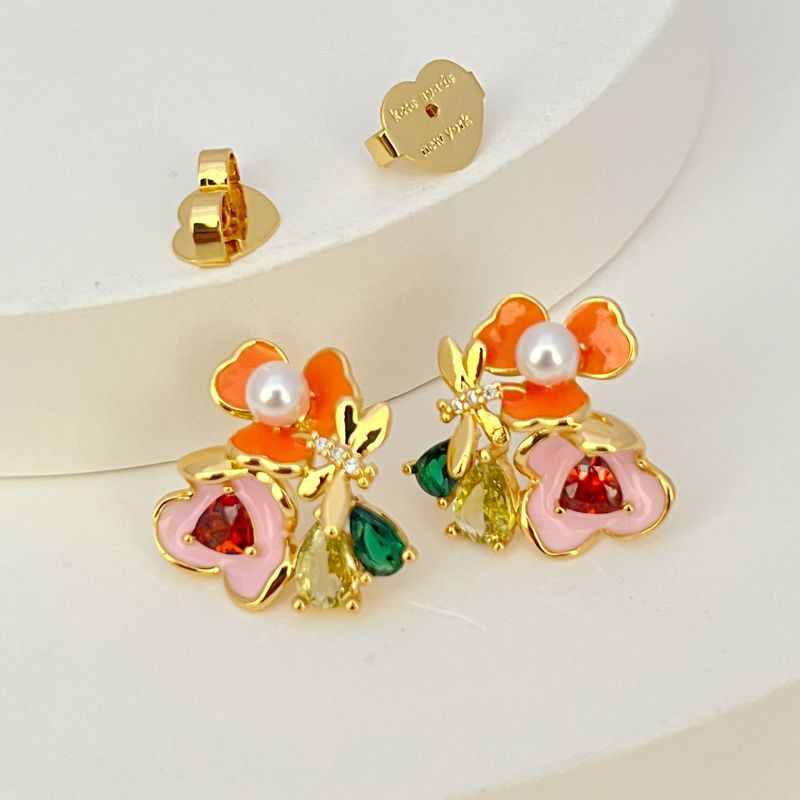 Earrings on a soft white or pale pink background, showcasing the vibrant multicolor floral cluster. Alt: “Kate Spade Abloom in Color Floral Cluster Stud Earrings – Multicolor Enamel Flower Jewelry.”