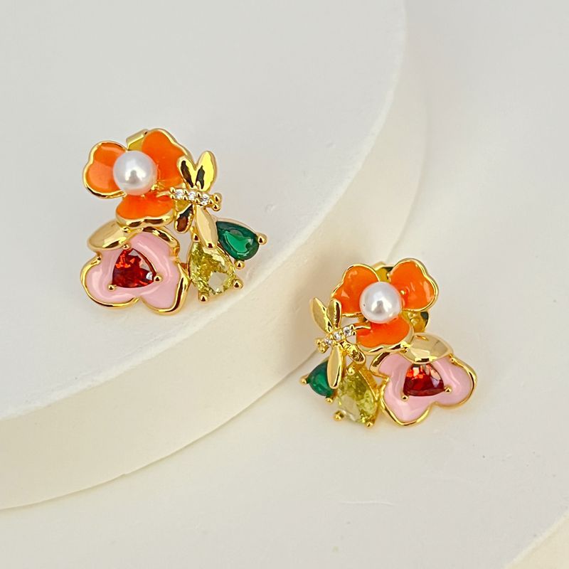 Earrings on a soft white or pale pink background, showcasing the vibrant multicolor floral cluster. Alt: “Kate Spade Abloom in Color Floral Cluster Stud Earrings – Multicolor Enamel Flower Jewelry.”