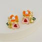 Earrings on a soft white or pale pink background, showcasing the vibrant multicolor floral cluster. Alt: “Kate Spade Abloom in Color Floral Cluster Stud Earrings – Multicolor Enamel Flower Jewelry.”