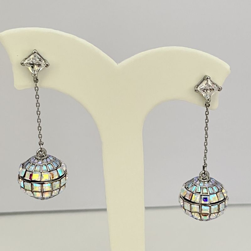 Earrings on a soft black or silver glitter background, showcasing the linear cascade of mirror tiles catching light. Alt: “Kate Spade Beaming Bright Disco Ball Linear Earrings – Mirror Tile Drop Jewelry.”