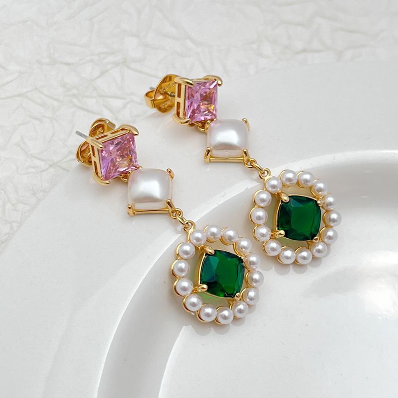 Earrings on a soft ivory or dusty blue background, showcasing the serene blue pearl center surrounded by a pavé crystal halo. Alt: “Kate Spade Blue Pearl Earrings – Gold & Blue Bridal Halo Jewelry.”