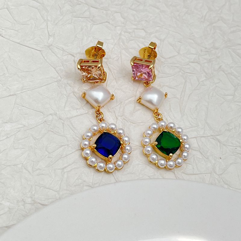 Earrings on a soft ivory or dusty blue background, showcasing the serene blue pearl center surrounded by a pavé crystal halo. Alt: “Kate Spade Blue Pearl Earrings – Gold & Blue Bridal Halo Jewelry.”