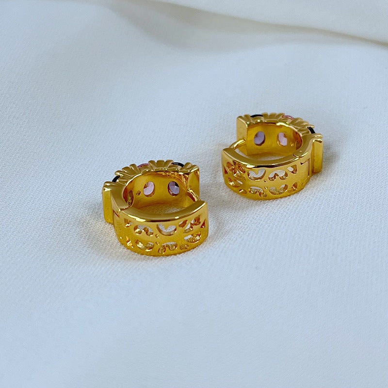 Earrings on a soft pastel pink or candy-striped background, showcasing the rainbow crystals along the gold hoop. Alt: “Kate Spade Candy Shop Small Stone Hoop Earrings – Rainbow Crystal Huggie Jewelry.”