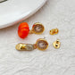  Earrings displayed side by side on a soft midnight blue or fairy tale-inspired background, showcasing the glass slipper heel and pumpkin clock charms. Alt: “Kate Spade Cinderella High Heels and Pumpkin Clock Earrings – Fairy Tale Novelty Jewelry.”