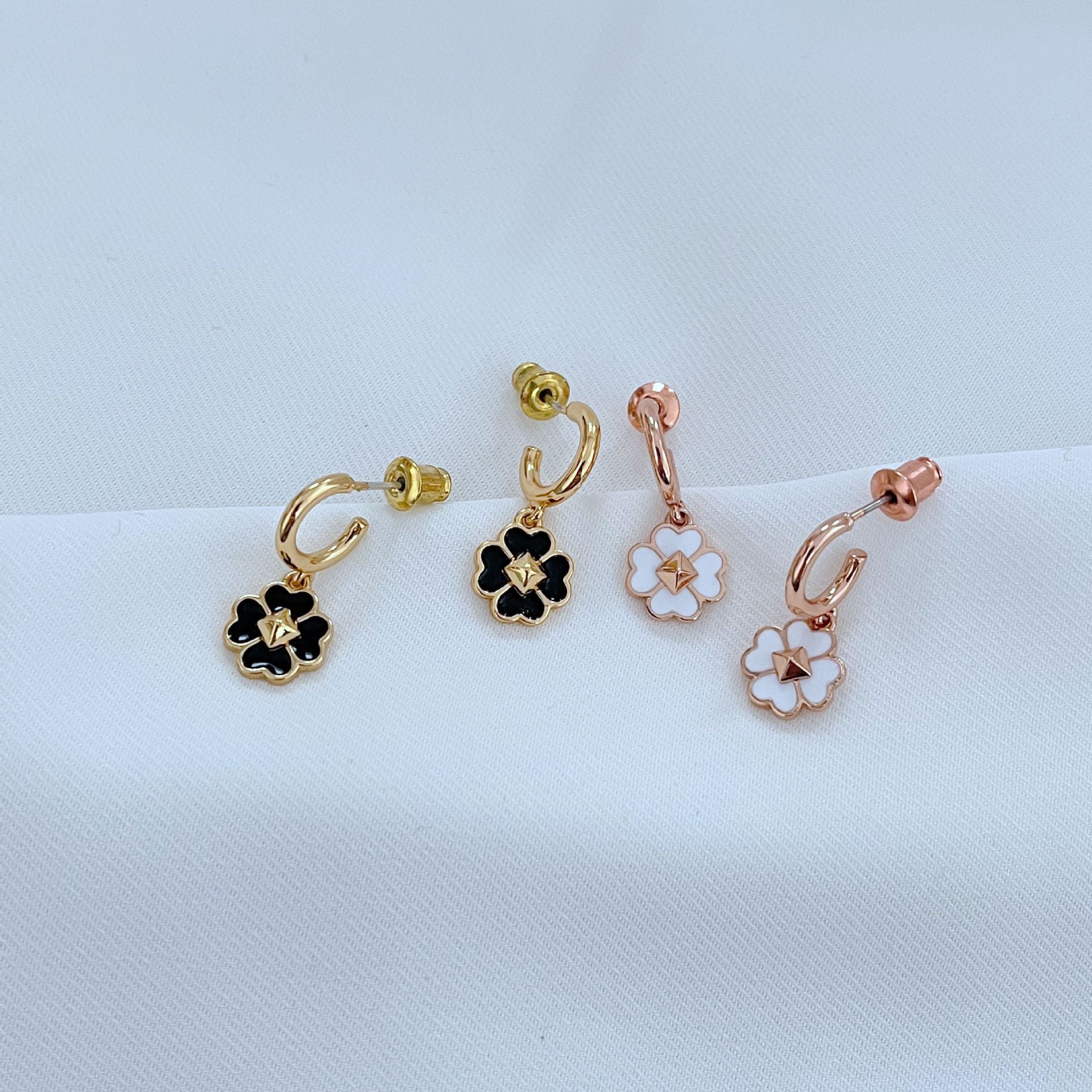 The necklace styled next to a deck of cards, a lucky coin, or on a minimalist surface, reinforcing themes of luck and modern design.