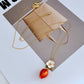 Necklace on a light pink or cream background, showcasing the strawberry pendant’s sparkle and shape. Alt: “Kate Spade Crystal Strawberry Pendant Necklace – Whimsical Jewelry for Women.