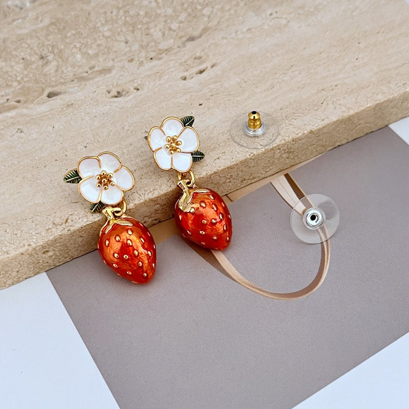 Necklace on a light pink or cream background, showcasing the strawberry pendant’s sparkle and shape. Alt: “Kate Spade Crystal Strawberry Pendant Necklace – Whimsical Jewelry for Women.