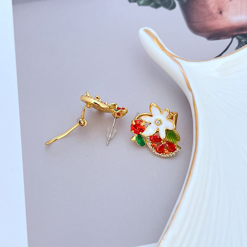 Earrings on a soft lavender or vineyard-inspired background, showcasing the glossy purple grape cluster and floral details. Alt: “Kate Spade Flower Grape Fruit Stud Earrings – Enamel Grape Jewelry Gift for Her.”