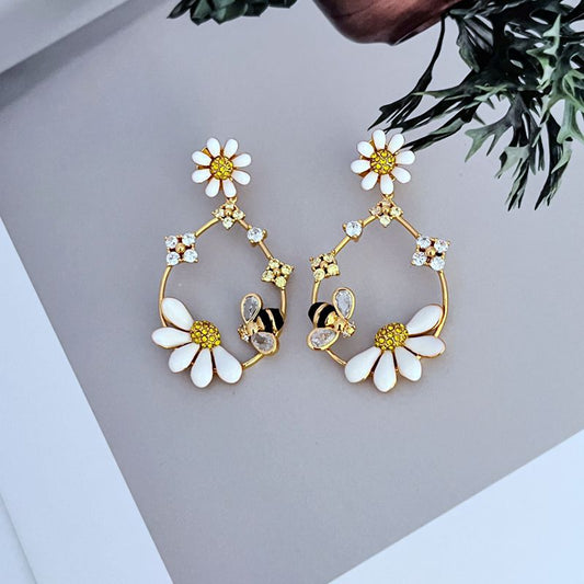  Earrings on a soft blush pink or garden green background, showcasing the pastel enamel flowers along the gold hoop. Alt: “Kate Spade Flower Hoop Earrings – Enamel Floral Hoop Jewelry.”