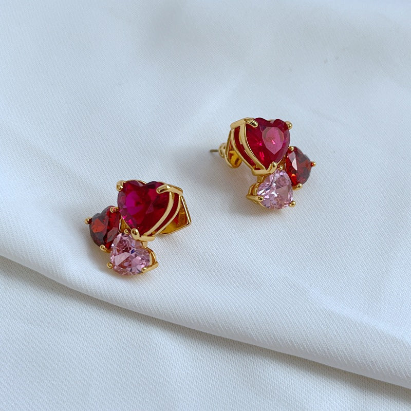 Earrings on a soft blush or cream background, showcasing the crystal-pavé heart shape. Alt: “Kate Spade Gold-Tone Heart Cubic Zirconia Earrings – Crystal Heart Stud Jewelry.”