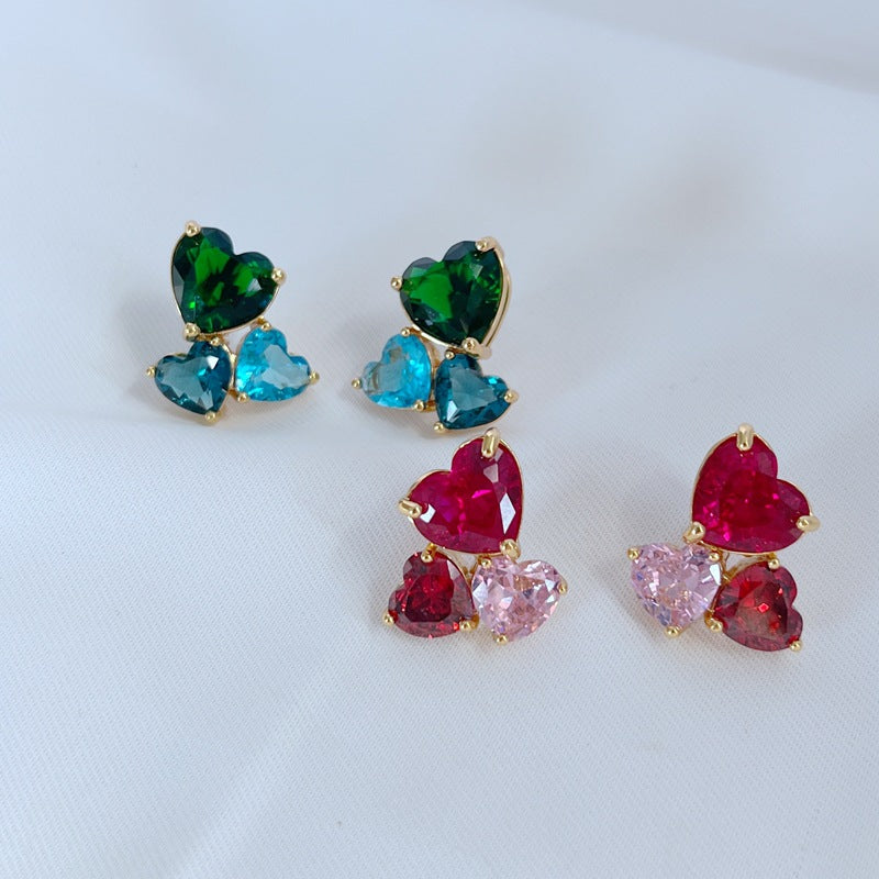 Earrings on a soft blush or cream background, showcasing the crystal-pavé heart shape. Alt: “Kate Spade Gold-Tone Heart Cubic Zirconia Earrings – Crystal Heart Stud Jewelry.”