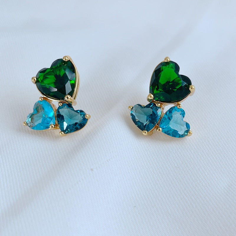 Earrings on a soft blush or cream background, showcasing the crystal-pavé heart shape. Alt: “Kate Spade Gold-Tone Heart Cubic Zirconia Earrings – Crystal Heart Stud Jewelry.”