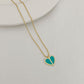Straight-on to clearly showcase the mini heart pendant with vibrant red enamel and the signature spade detail.