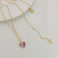 Straight-on to clearly showcase the mini heart pendant with vibrant red enamel and the signature spade detail.