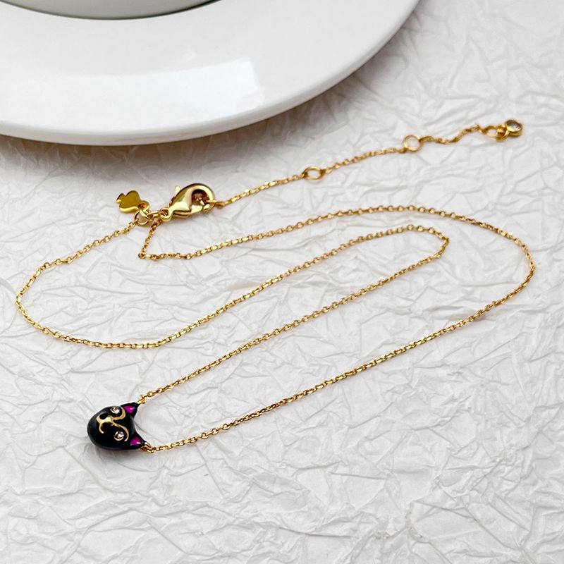 Mini cat pendant necklace on a soft, neutral background, emphasizing its tiny scale and charm shape. Alt: “Kate Spade House Cat Mini Pendant Necklace – Dainty Cat Lover Jewelry.”