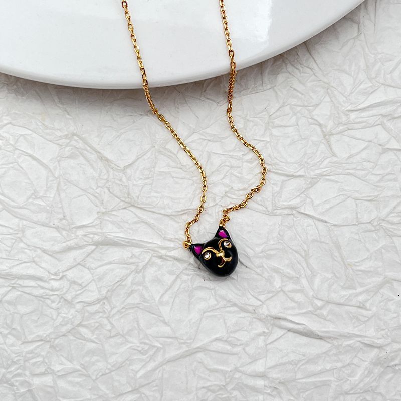 Mini cat pendant necklace on a soft, neutral background, emphasizing its tiny scale and charm shape. Alt: “Kate Spade House Cat Mini Pendant Necklace – Dainty Cat Lover Jewelry.”