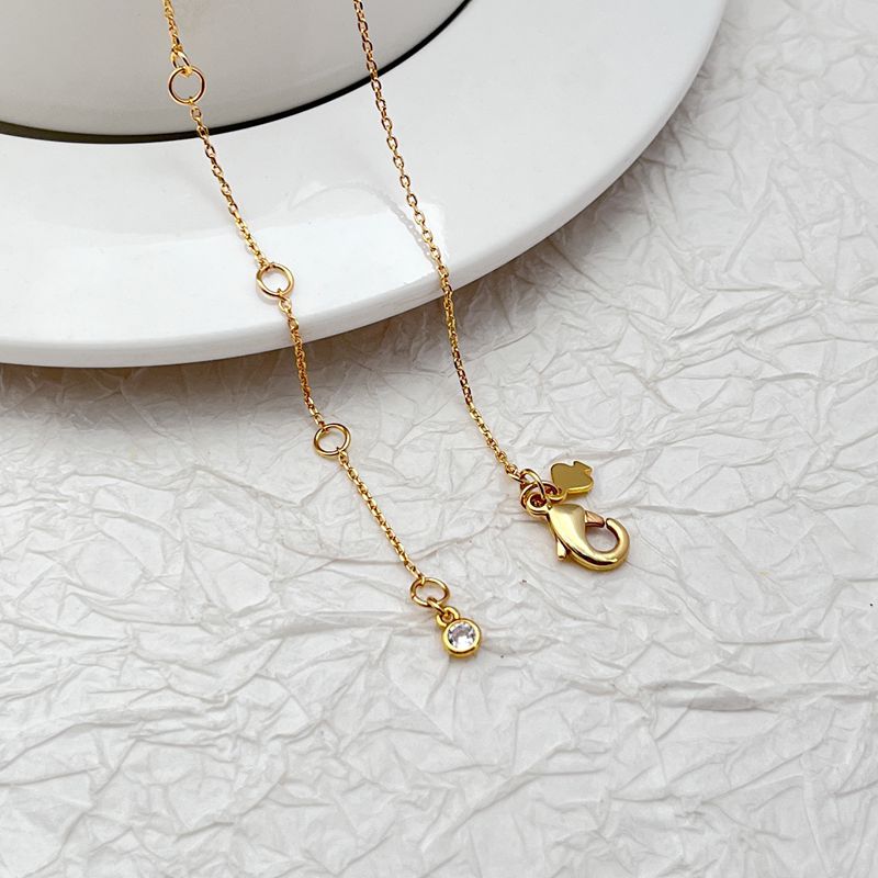 Macro focus on the cat pendant, showing its silhouette, possible textured fur engraving, and secure loop. Alt: “Detailed Mini Cat Charm – Kate Spade Necklace.”