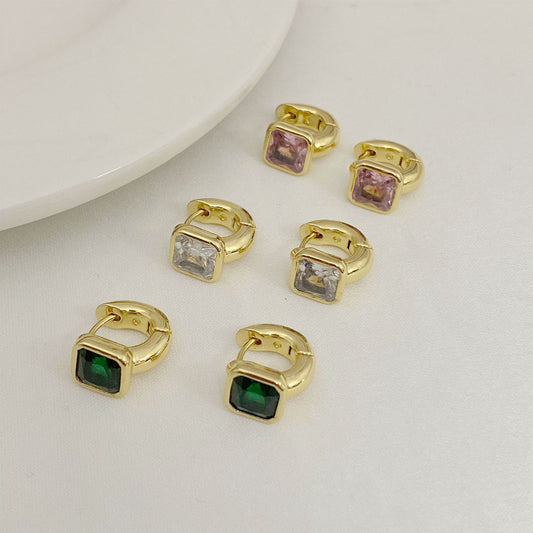 High-definition shot of the pair of earrings laid flat on pure white background, arranged symmetrically.