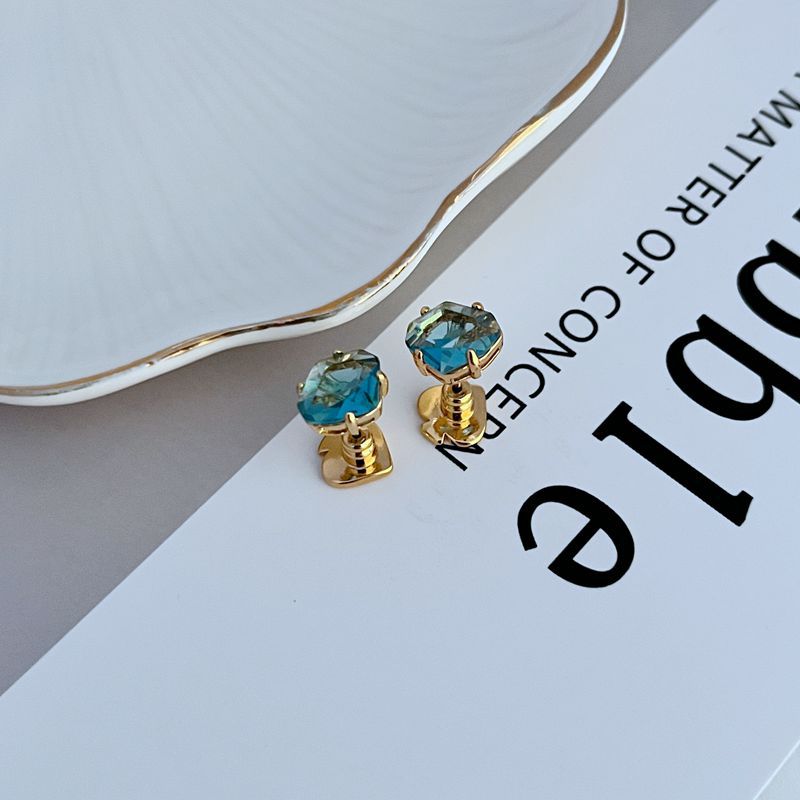 Earrings on a soft white or pale blue background, highlighting the light blue enamel disc with gold "Rise and Shine" lettering. Alt: “Kate Spade Light Blue Rise and Shine Earrings – Blue and Gold Inspirational Jewelry.”