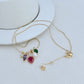 Necklace displayed against a festive background (e.g., evergreen branches, red velvet, or holiday wrapping), highlighting the colorful light bulbs. Alt: “Kate Spade Holiday Light Necklace – Festive Christmas Light Pendant Jewelry.”