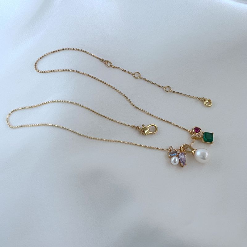 Clean, macro shot of the necklace on a plain background, emphasizing the petite charm and fine chain.