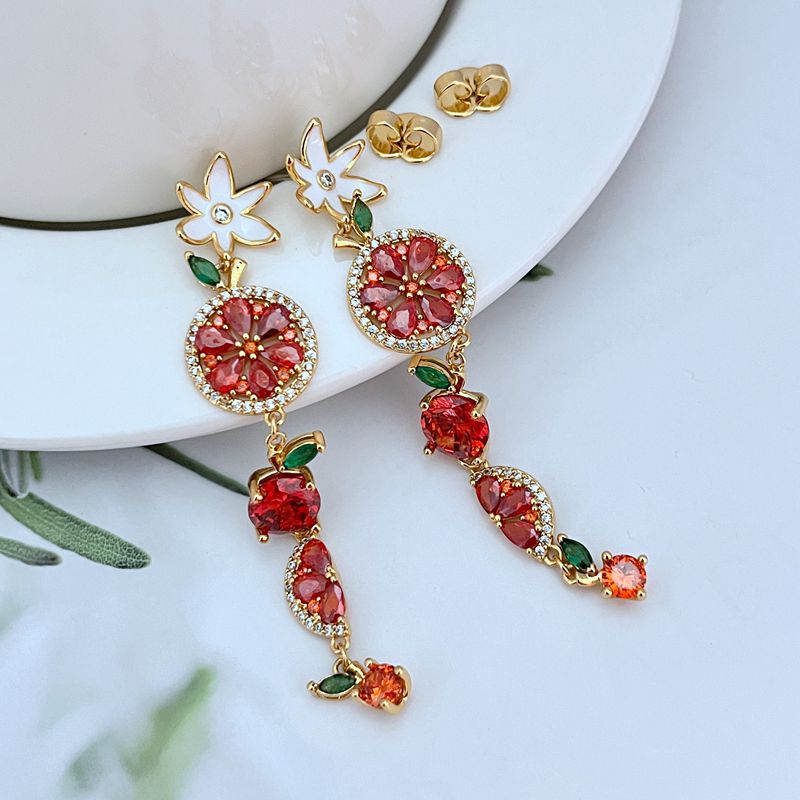 Earrings on a soft lemon yellow or fresh mint green background, showcasing the colorful cascade of fruit and flower charms. Alt: “Kate Spade Multicolour Flower Fruit Dangle Earrings – Enamel Fruit & Floral Jewelry.”