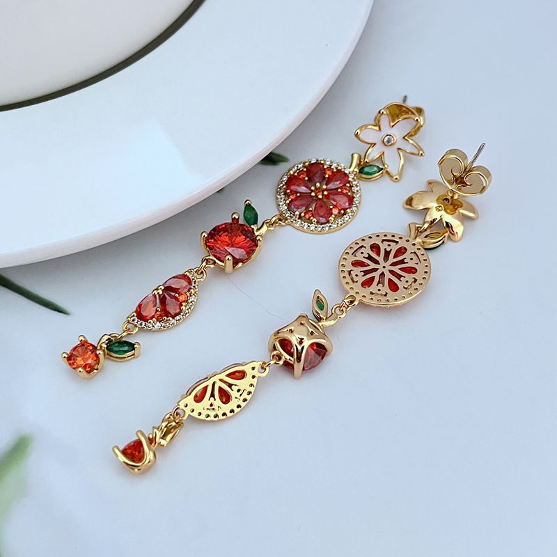 Earrings on a soft lemon yellow or fresh mint green background, showcasing the colorful cascade of fruit and flower charms. Alt: “Kate Spade Multicolour Flower Fruit Dangle Earrings – Enamel Fruit & Floral Jewelry.”