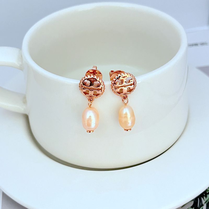 Earrings on a soft sand-beige or seafoam green background, highlighting the warm pink conch pearl and gold setting. Alt: “Kate Spade New York Conch Pearl Gold Tone Earrings – Shell Pearl Drop Jewelry.”
