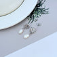 Macro focus on one conch pearl, showing its organic shape, warm pink hue, and natural iridescence. Alt: “Luminous Conch Pearl Detail – Kate Spade Gold Tone Earrings.”