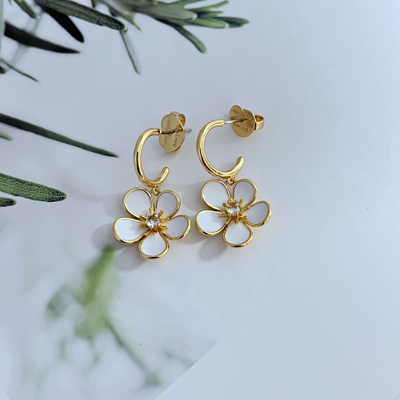  Earrings on a soft cream or blush background, showcasing the ivory enamel pansy within the gold-tone disc. Alt: “Kate Spade New York Gold-Tone Cream Disco Pansy Earrings – Vintage Floral Disc Jewelry.”