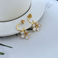  Earrings on a soft cream or blush background, showcasing the ivory enamel pansy within the gold-tone disc. Alt: “Kate Spade New York Gold-Tone Cream Disco Pansy Earrings – Vintage Floral Disc Jewelry.”