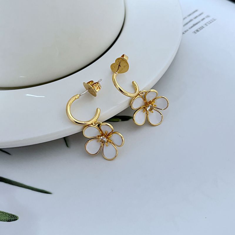  Earrings on a soft cream or blush background, showcasing the ivory enamel pansy within the gold-tone disc. Alt: “Kate Spade New York Gold-Tone Cream Disco Pansy Earrings – Vintage Floral Disc Jewelry.”