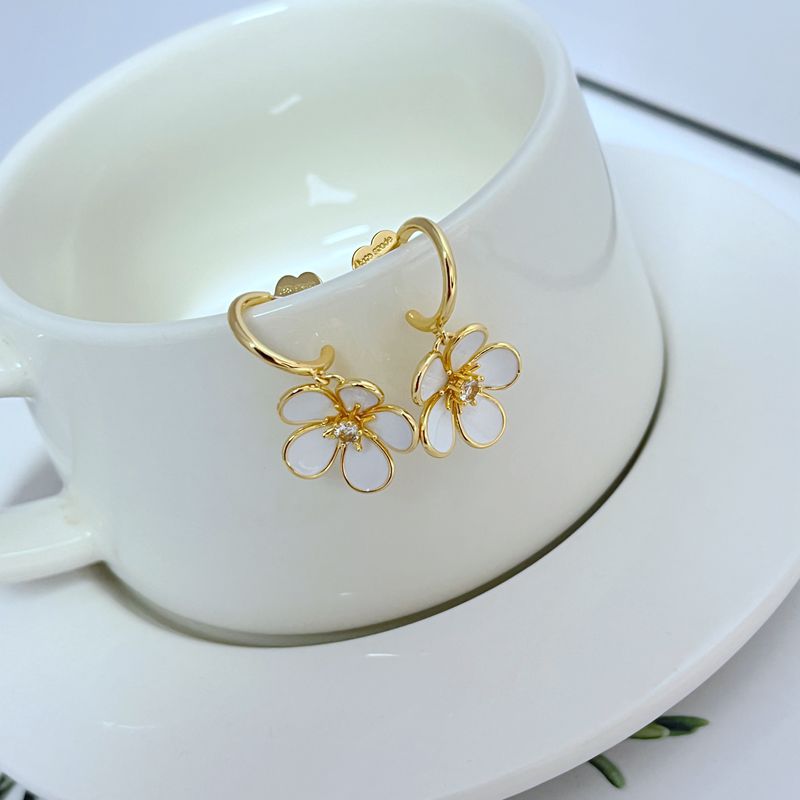  Earrings on a soft cream or blush background, showcasing the ivory enamel pansy within the gold-tone disc. Alt: “Kate Spade New York Gold-Tone Cream Disco Pansy Earrings – Vintage Floral Disc Jewelry.”