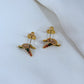 Earrings on a soft sage green or misty blue background, showcasing the hummingbird charm with iridescent enamel wings. Alt: “Kate Spade New York Hummingbird Earrings – Enamel Bird Drop Jewelry.”