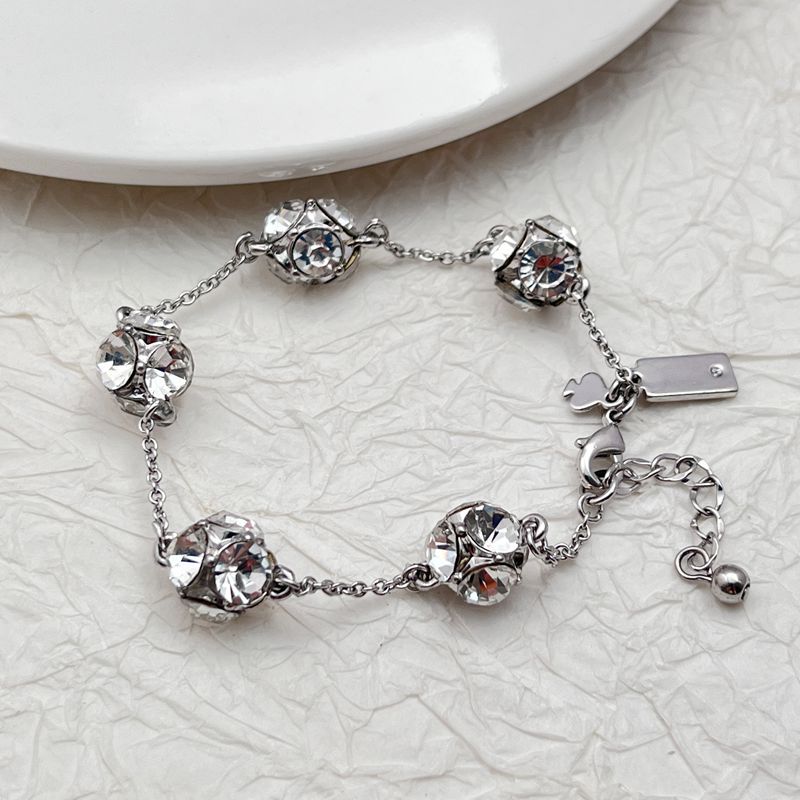  Bracelet on a soft cream or warm terracotta background, emphasizing the warm glow of the orange crystals. Alt: “Kate Spade Lady Marmalade Station Bracelet – Citrine Crystal Jewelry.”