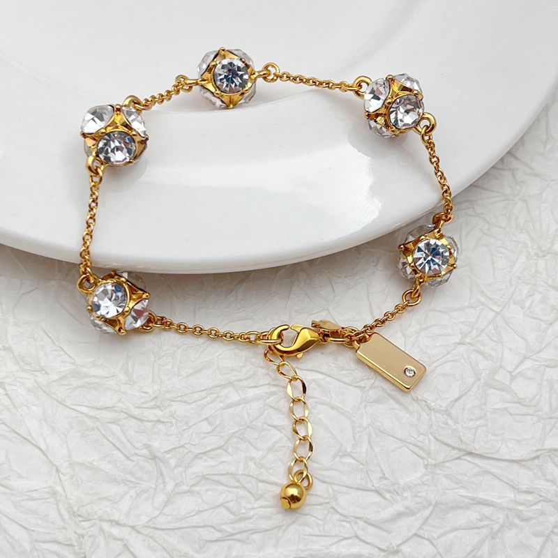  Bracelet on a soft cream or warm terracotta background, emphasizing the warm glow of the orange crystals. Alt: “Kate Spade Lady Marmalade Station Bracelet – Citrine Crystal Jewelry.”