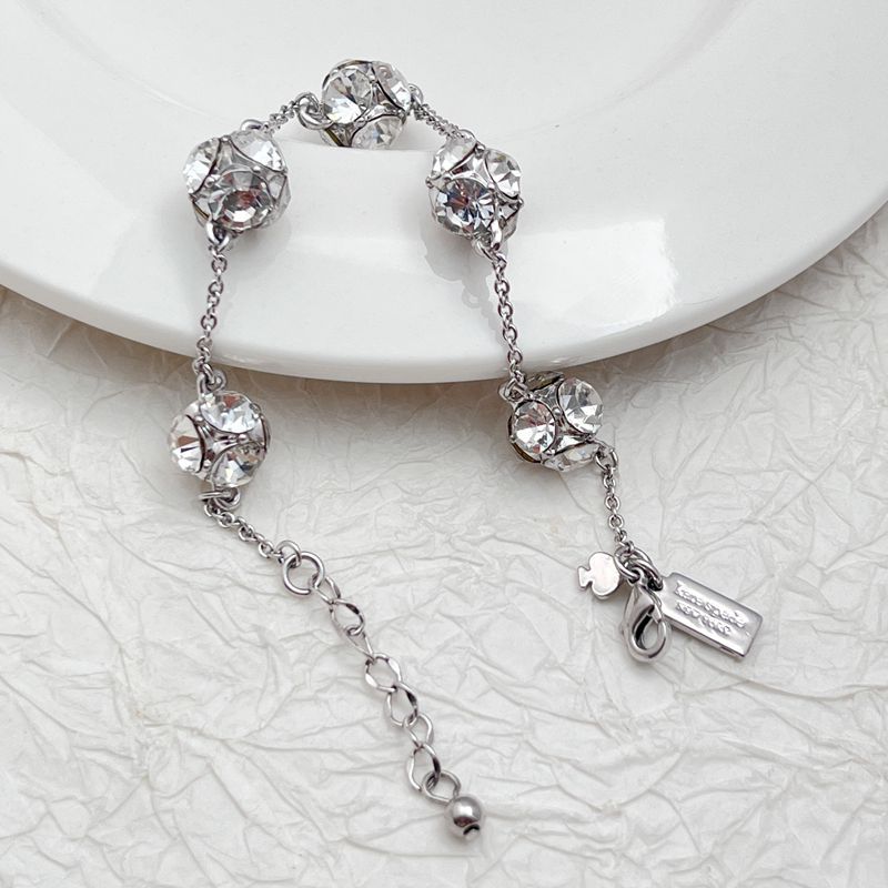  Bracelet on a soft cream or warm terracotta background, emphasizing the warm glow of the orange crystals. Alt: “Kate Spade Lady Marmalade Station Bracelet – Citrine Crystal Jewelry.”