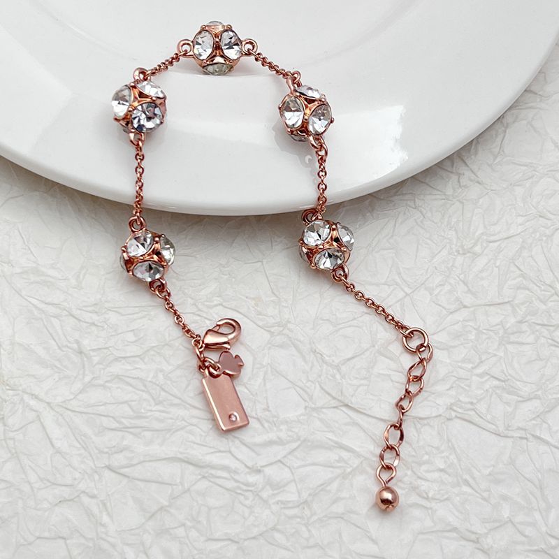  Bracelet on a soft cream or warm terracotta background, emphasizing the warm glow of the orange crystals. Alt: “Kate Spade Lady Marmalade Station Bracelet – Citrine Crystal Jewelry.”